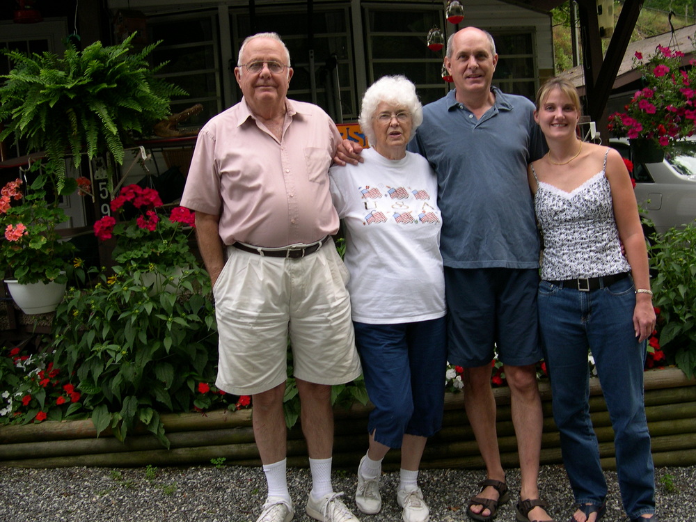 Dad, Mom, Me, daughter Anne in front of the cabin